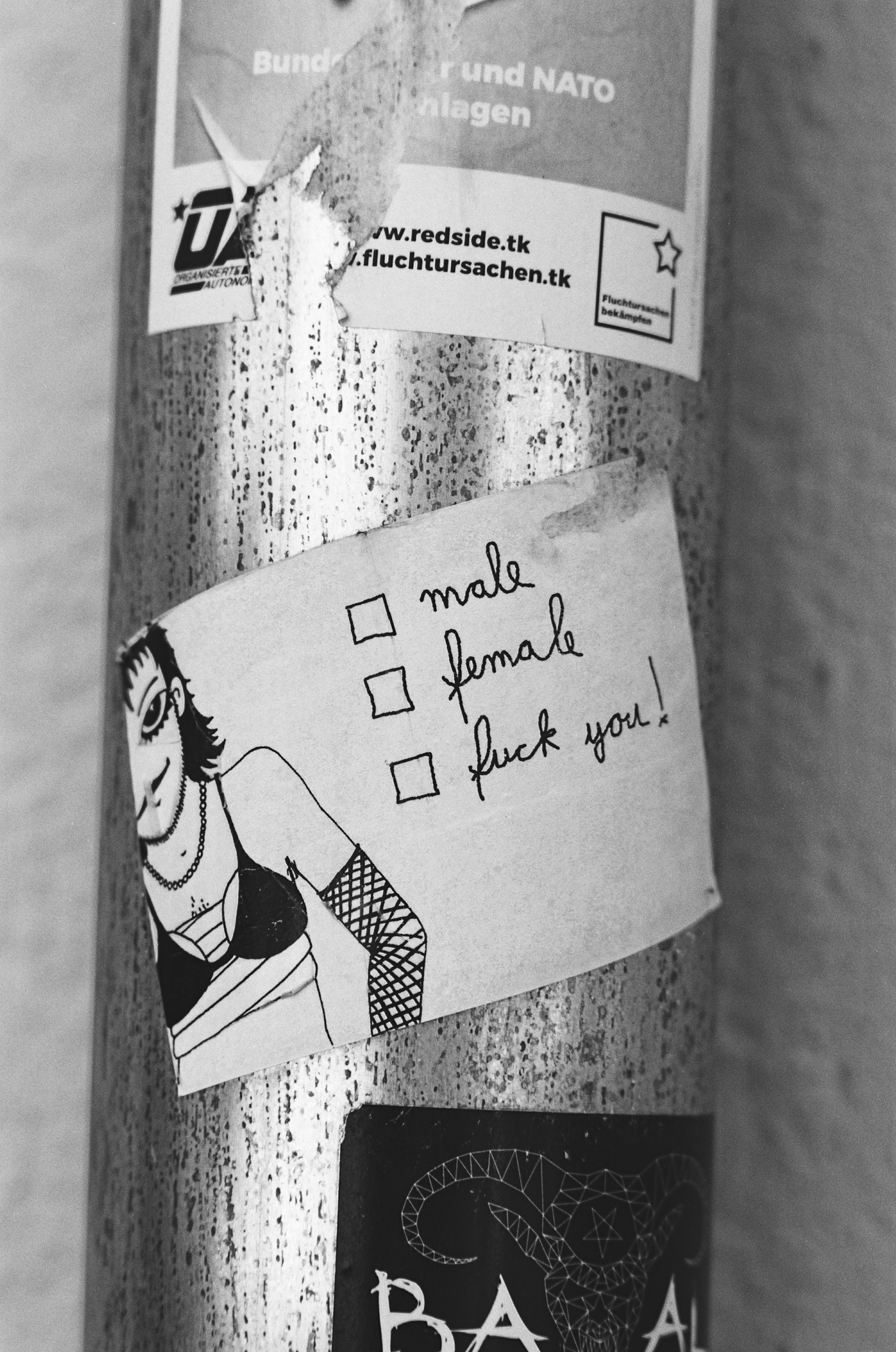 Urban street art sticker - FEMAL MALE FUCK YOU! Made with Leica R7 (1994) and Summicron-R 2.0 90mm (1981). Hi-Res analog scan by: www.totallyinfocus.com – ADOX HR 50 (expired 1995)